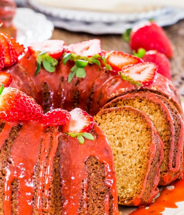 side view shot of a sliced pound cake with strawberry glaze