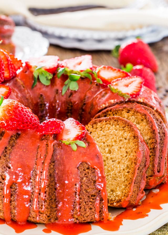 side view shot of a sliced pound cake with strawberry glaze