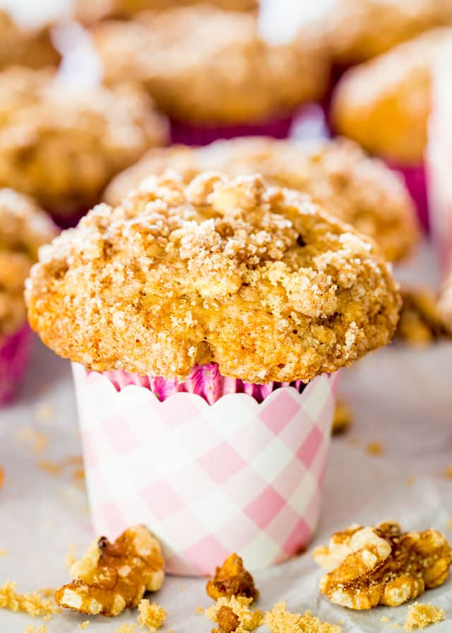 Coffee Cake Muffins in purple liners surrounded with walnuts