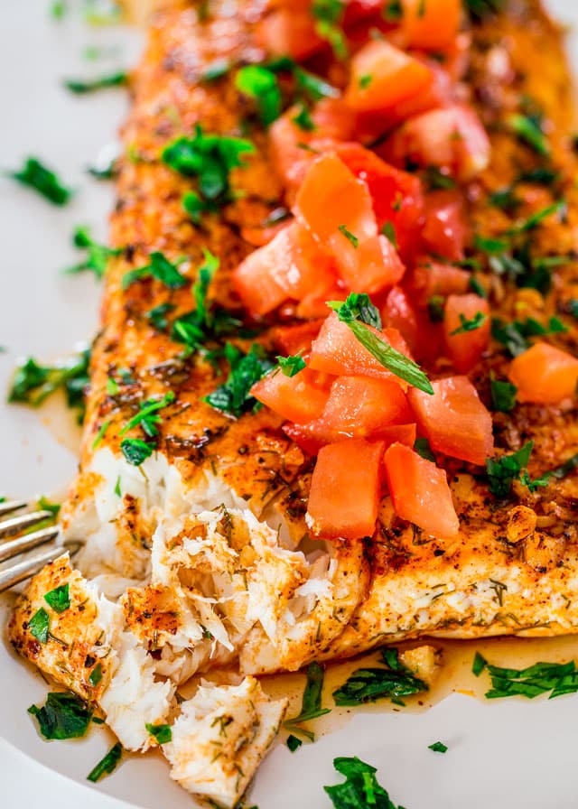 lemon garlic halibut topped with chopped tomatoes and parsley