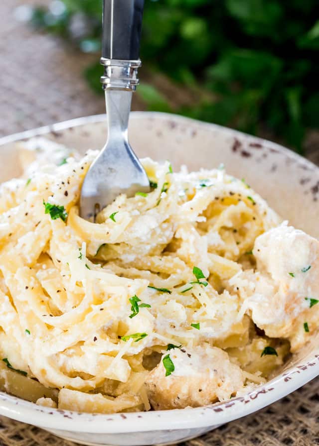 Creamy Chicken Alfredo in a plate with a fork in it