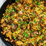 overhead shot of a pan full of couscous pilaf with sauteed mushrooms