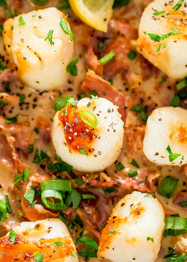 Garlic Butter Scallops surrounded by sauce and prosciutto