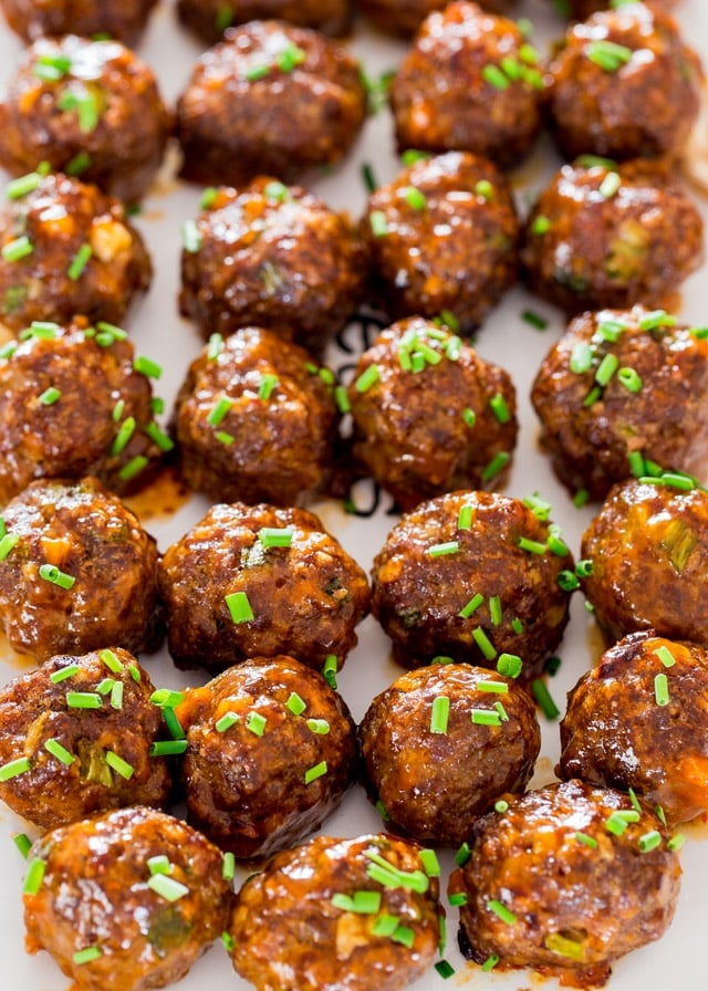 Korean Meatballs lined up on a baking sheet topped with chives