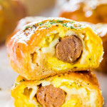 side view close up shot of a sausage and egg breakfast roll cut in half exposing the center