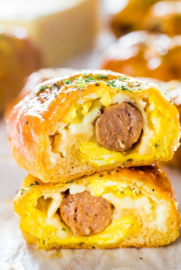 side view close up shot of a sausage and egg breakfast roll cut in half exposing the center