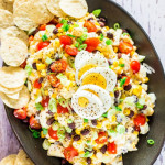 overhead shot of tex mex potato salad on a serving platter surrounded by tortilla chips