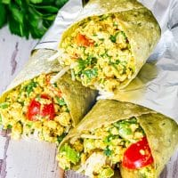 3 vegan breakfast burritos wrapped in foil