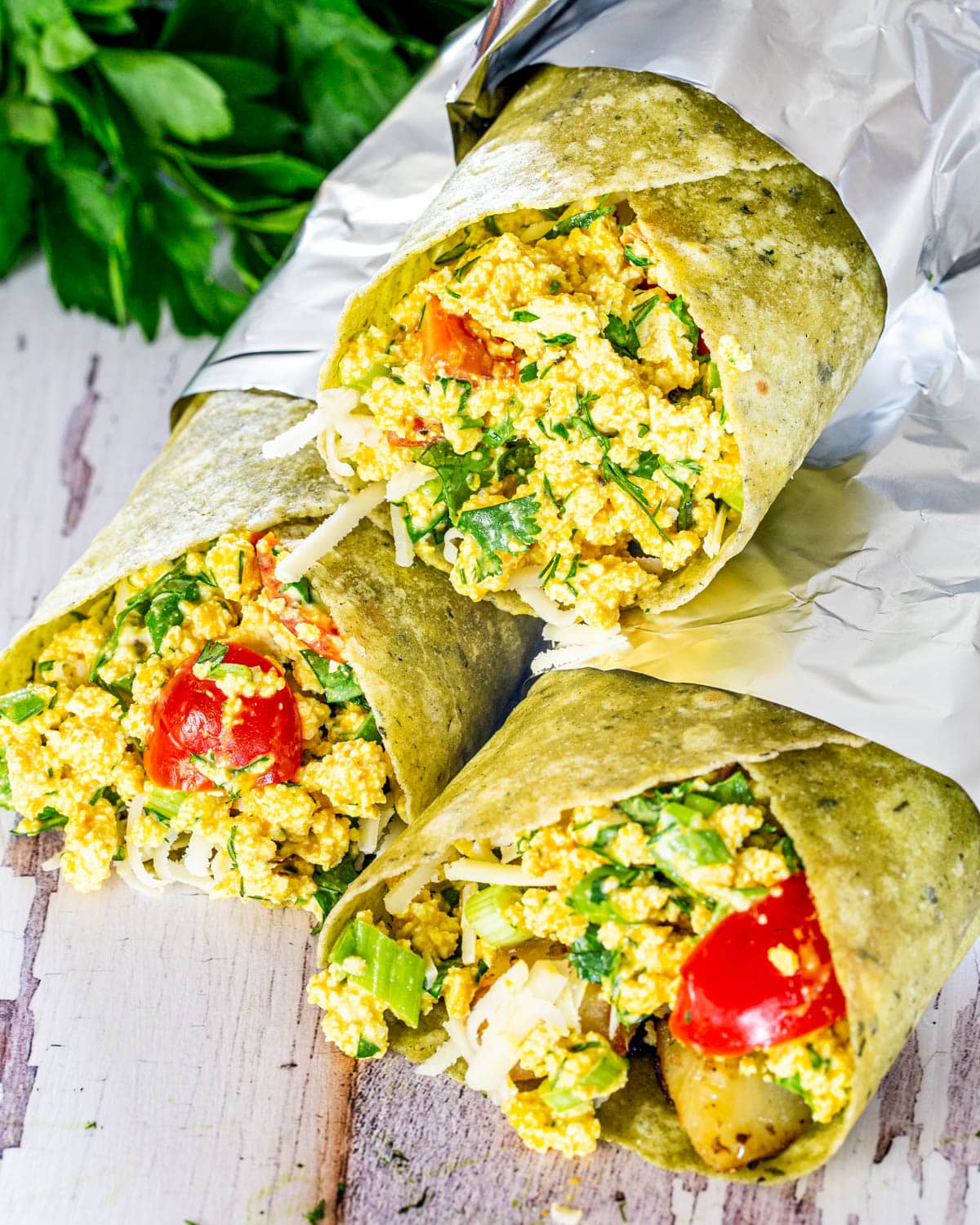3 vegan breakfast burritos stacked on top of each other