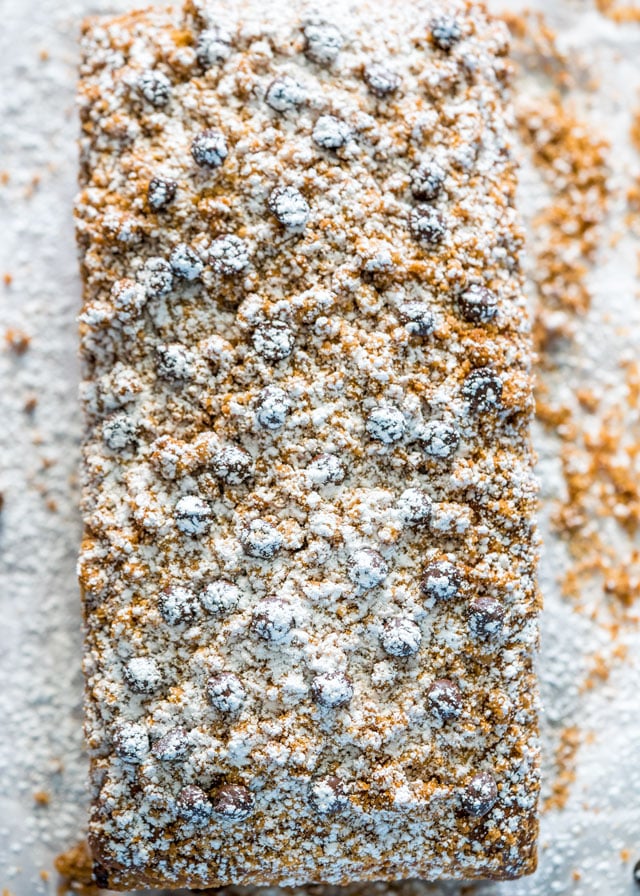 overhead shot of crumb cake sprinkled with chocolate chips and powdered sugar