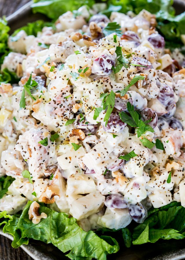 Waldorf Salad over lettuce topped with parsley and pepper