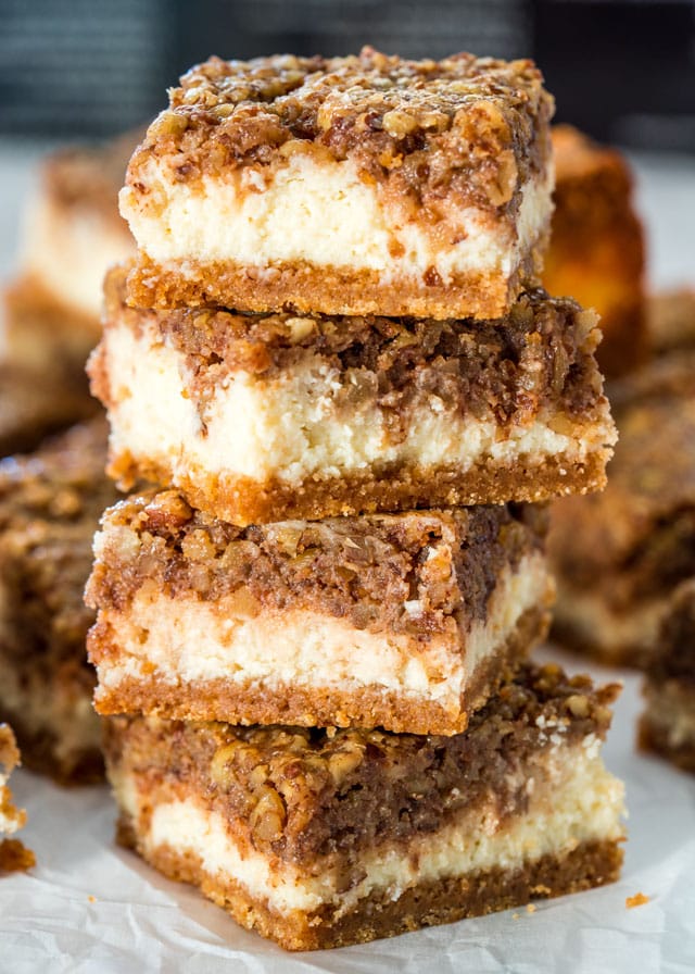 4 Pecan Pie Cheesecake Bars stacked on top of each other