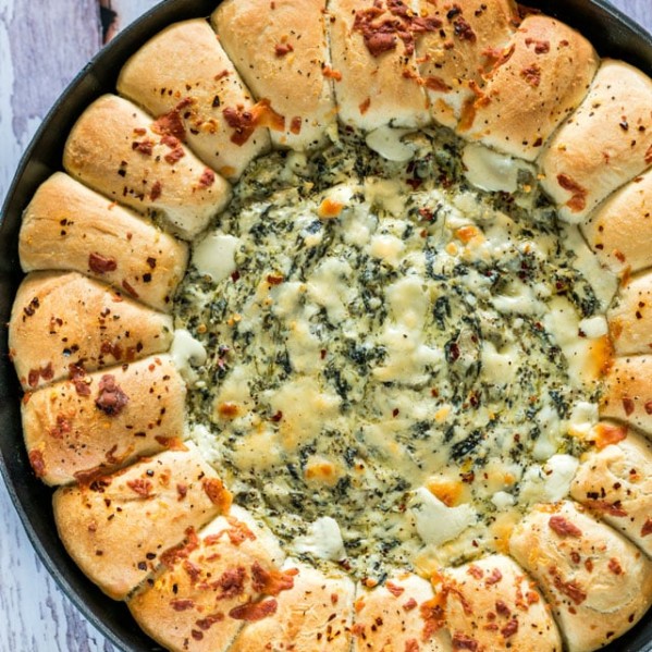 overhead shot of skillet pull apart bread with spinach and artichoke dip