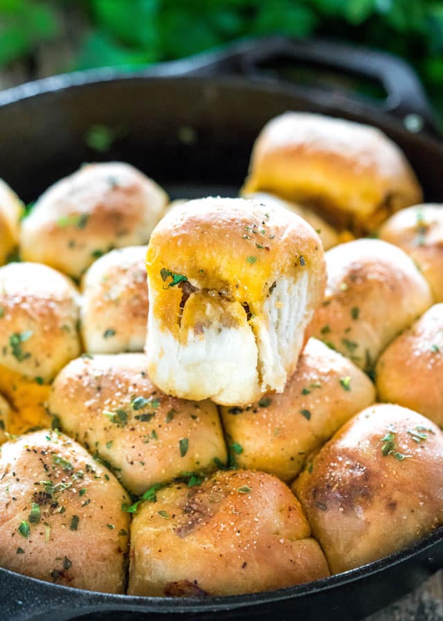 a skillet full of buns stuffed with cheese and beef
