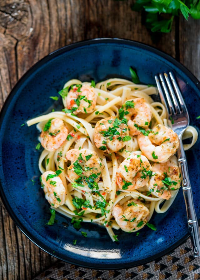 overhead of a plate of fettuccine topped with shrimp and parsley