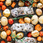 overhead shot of greek pork loin ribs and assorted vegetables on a sheet pan