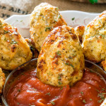 close up shot of a cauliflower tot sitting in the bowl of dip