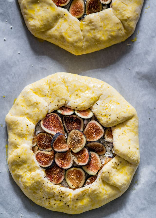 a galette filled with figs and brushed with egg wash ready to be baked