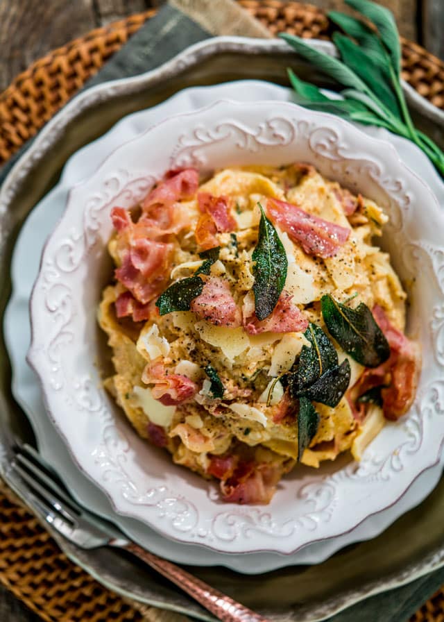 overhead of a bowl full of pasta, crispy sage, and pancetta