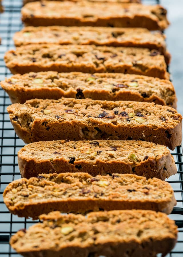 biscotti loaded with dried fruit and nuts freshly out of the oven on a cooling rack
