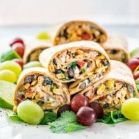 southwestern wraps stacked on a plate garnished with grapes