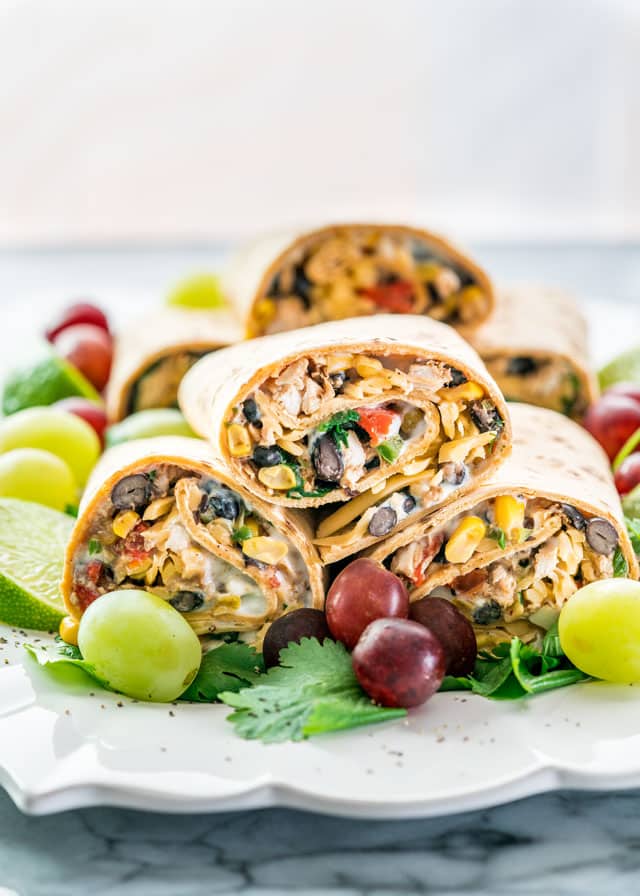 Southwestern Wraps  containing black beans, chicken, spinach, roasted red peppers and a low fat sour cream and blue cheese spread. 