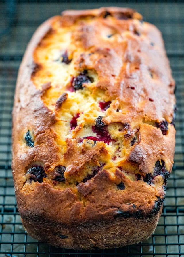 a lemon blueberry loaf fresh out of the oven on a cooling rack