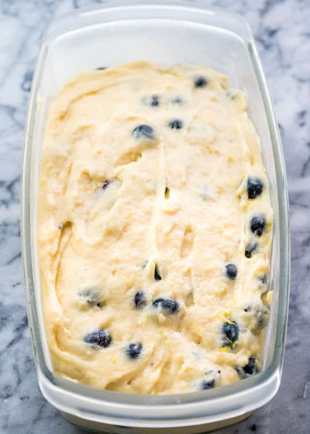 a glass loaf pan with lemon blueberry batter ready to go into the oven