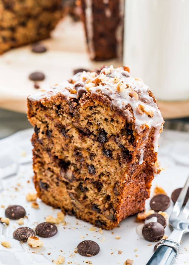 a slice of coffee cake on a plate with chocolate chips and a fork