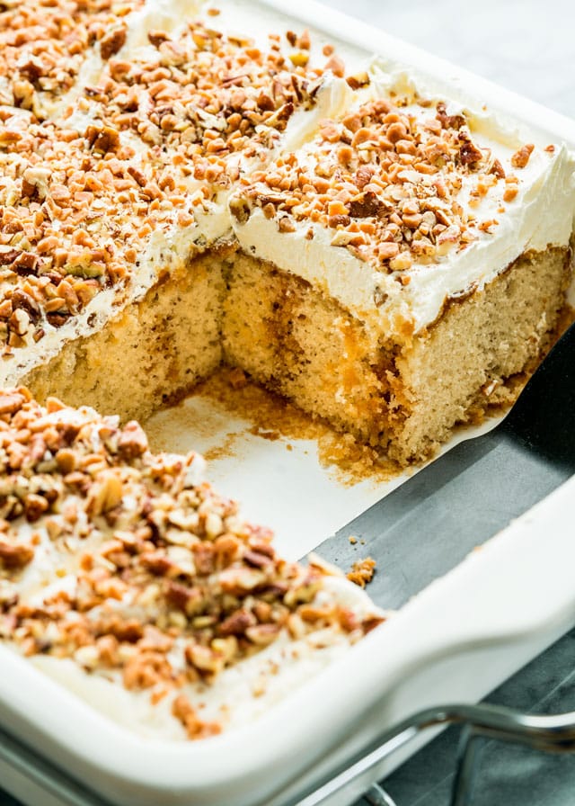 a poke cake in a pan with a few slices taken out