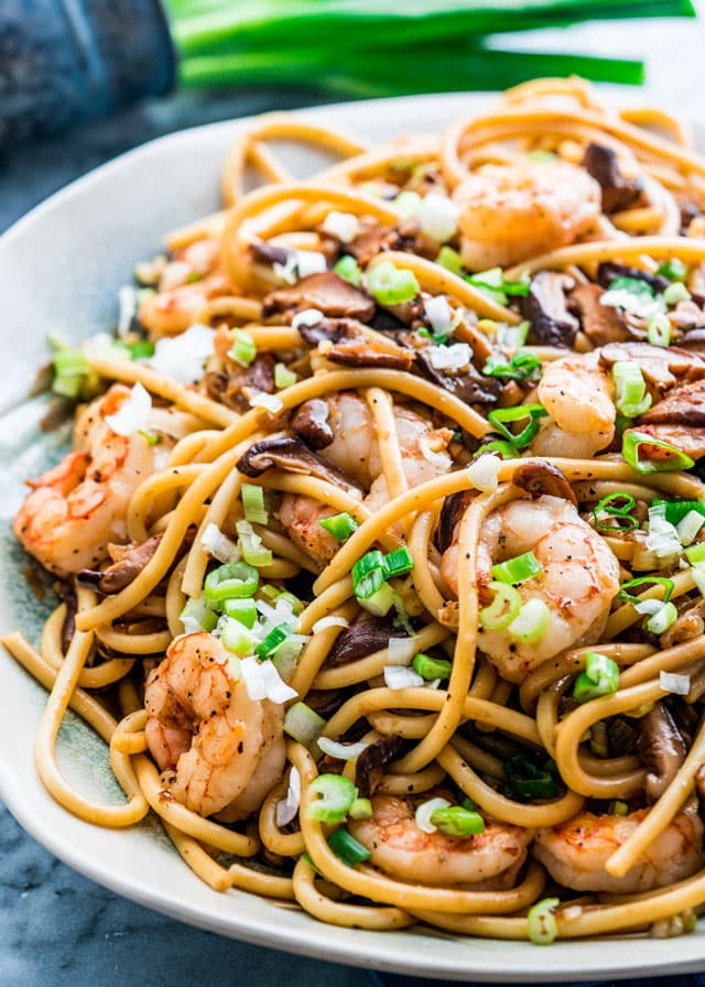 a plate full of noodles with shiitake mushrooms and shrimp