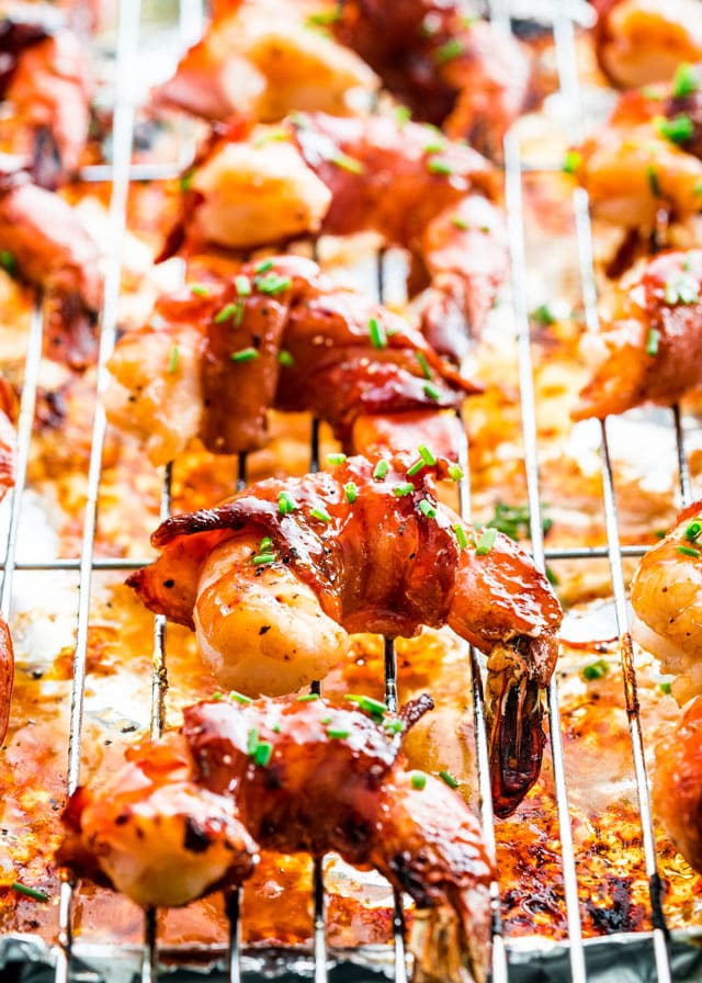 bacon wrapped shrimp lined up on a baking rack