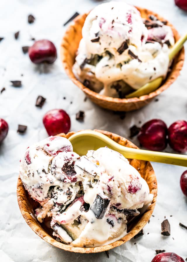 overhead of 2 waffle bowls filled with chocolate cherry ice cream with a spoon