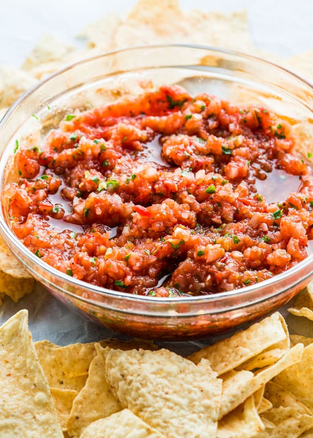 Homemade Salsa in a bowl surrounded with tortilla chips