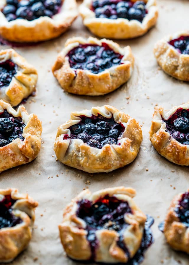 mini blueberry galettes fresh out of the oven on a baking sheet