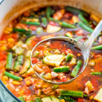 overhead shot of a ladle taking a scoop of summer chicken and vegetable soup