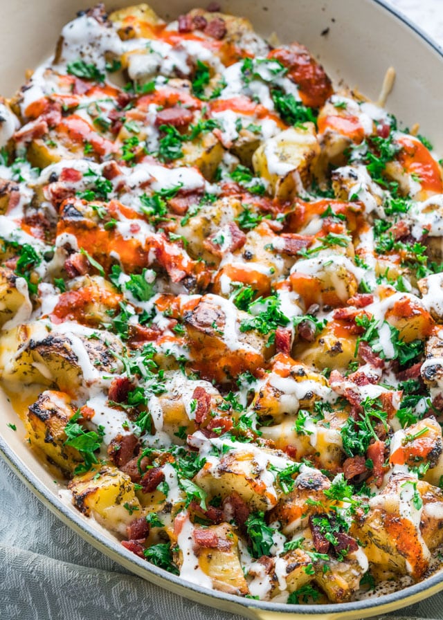 closeup of cheesy ranch bacon potatoes in a large dish