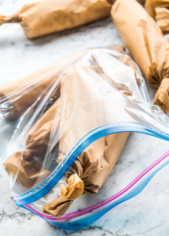 breakfast wraps wrapped up in parchment paper in a freezer bag