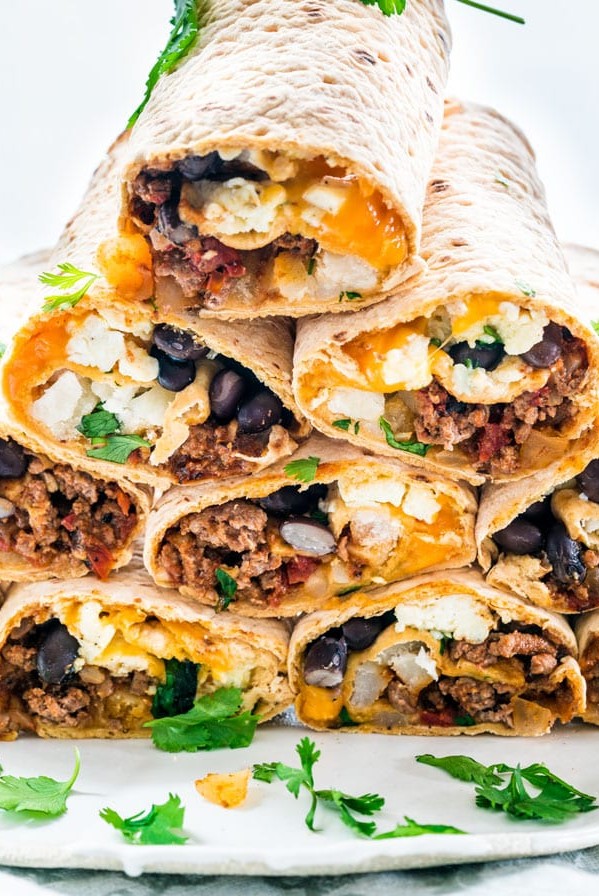 tex mex breakfast wraps stacked on a plate