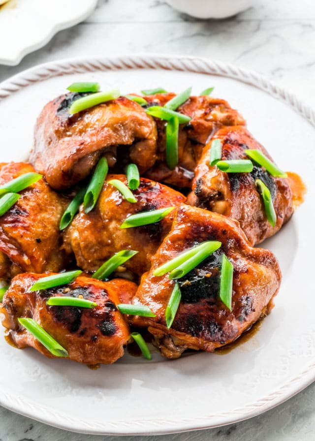 Instant Pot Teriyaki Chicken on a white plate garnished with green onion
