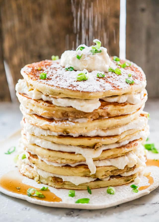 Icing sugar being dusted over a stack of Jalapeno Popper Pancakes