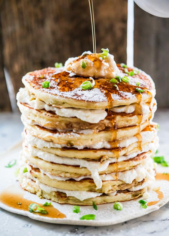 Maple syrup drizzling over a stack of 8 Jalapeno Popper Pancakes