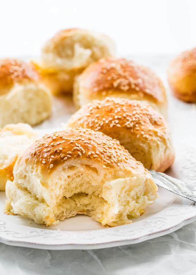side view shot of a soft buttermilk dinner roll on a plate