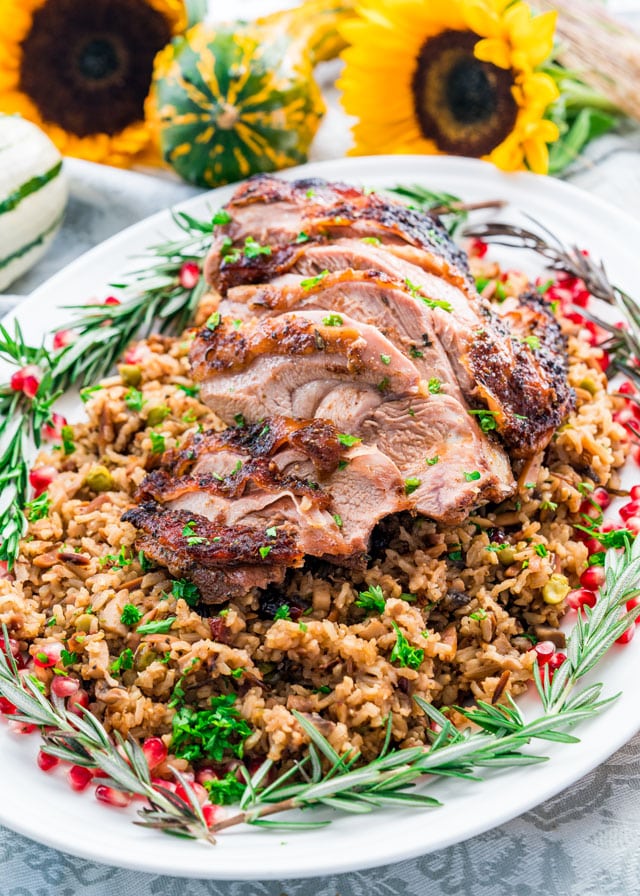 a platter of sliced turkey thighs on a bed of harvest rice