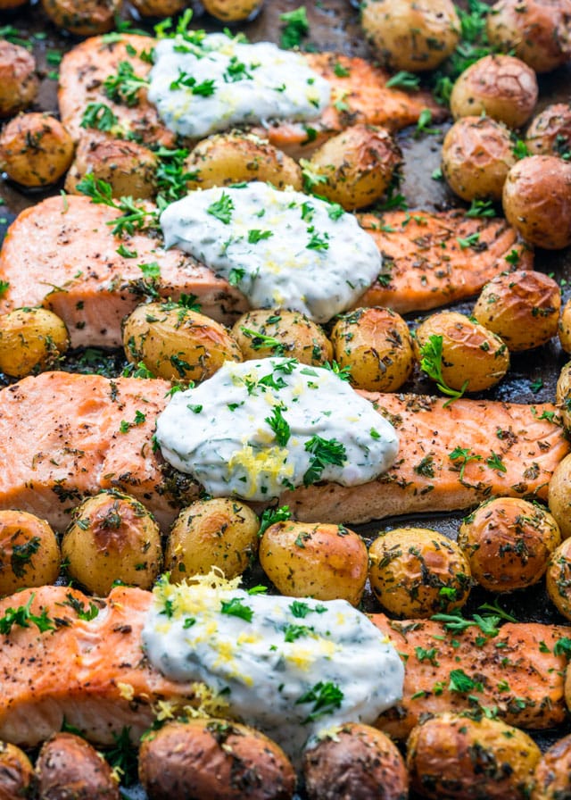 finished Salmon with Dill Sauce and Baby Potatoes on a sheet pan
