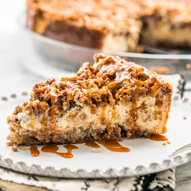 A piece of Pecan Pie Cheesecake drizzled with dulce de leche.