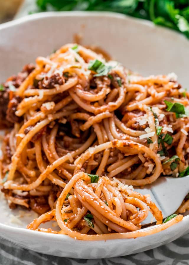 a plate with spaghetti bolognese and a fork