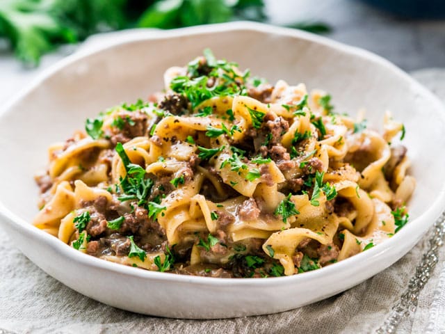 instant pot beef stroganoff in a white plate on fabric