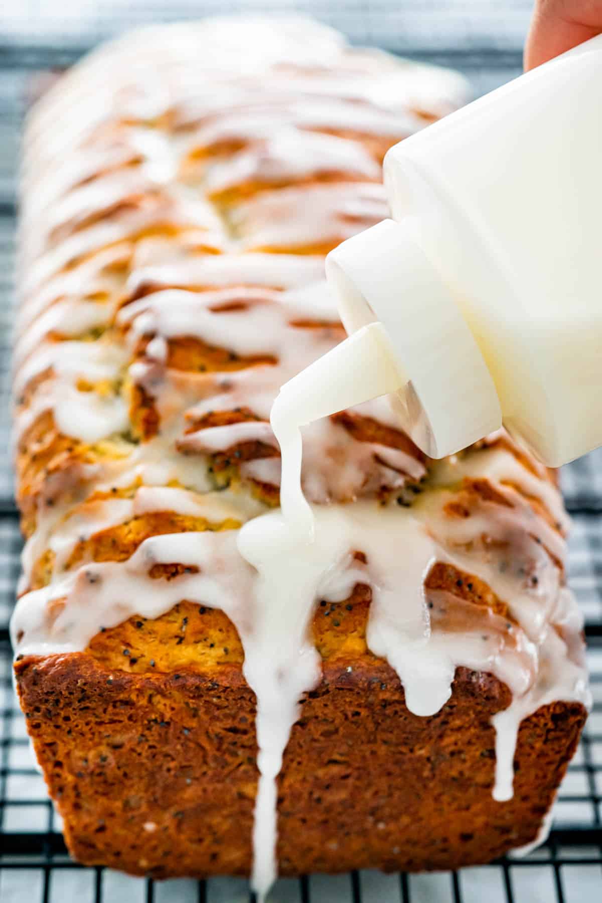 icing a lemon poppy seed bread with lemon icing