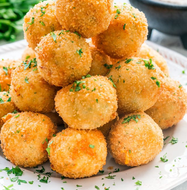 side view shot of a stack of potato croquettes on a plate